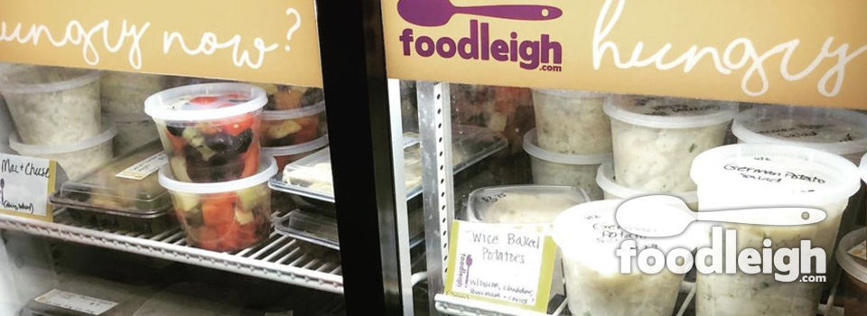 closeup of top shelf of deli case with assorted soups, desserts, sides and meals